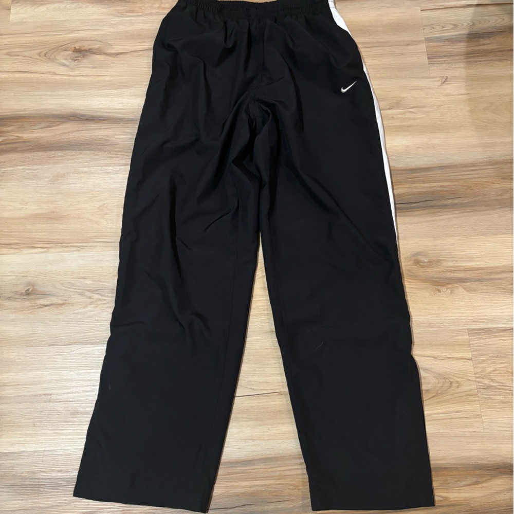 Black and white baggy track pants with zipper at bottom